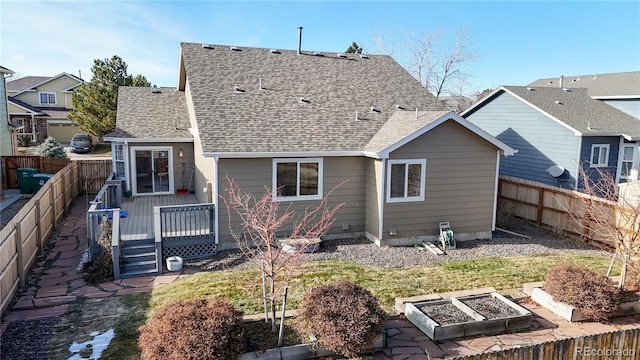 rear view of house featuring a deck