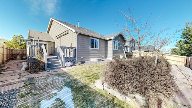 back of house with a yard and a wooden deck