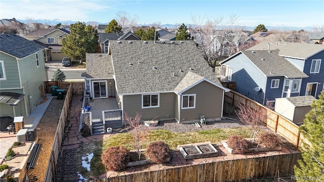 rear view of property featuring a deck