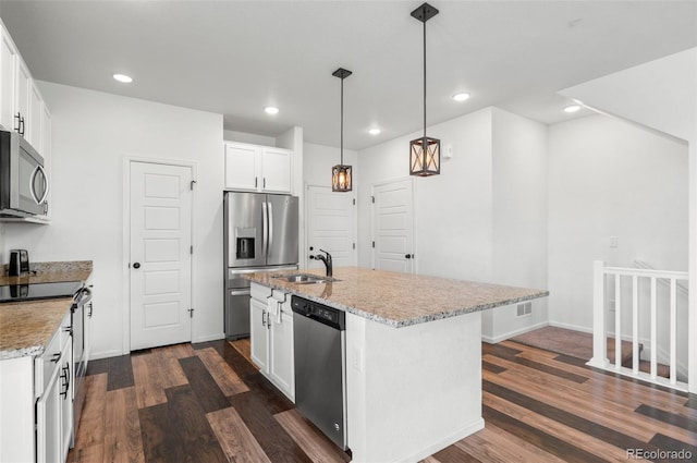 kitchen with white cabinetry, a center island with sink, and appliances with stainless steel finishes