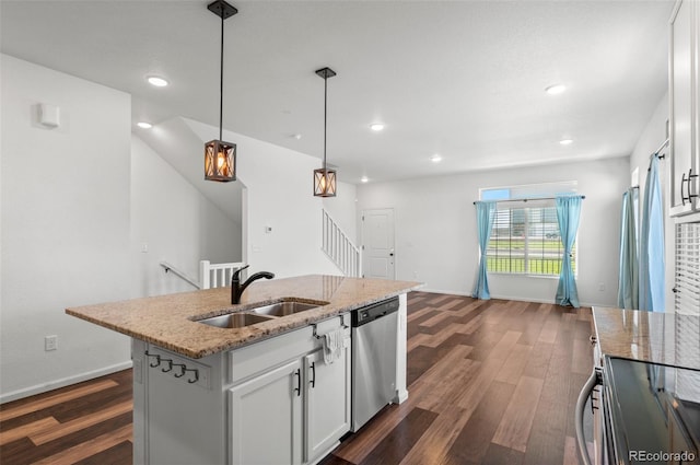 kitchen with a kitchen island with sink, white cabinets, appliances with stainless steel finishes, decorative light fixtures, and dark hardwood / wood-style flooring