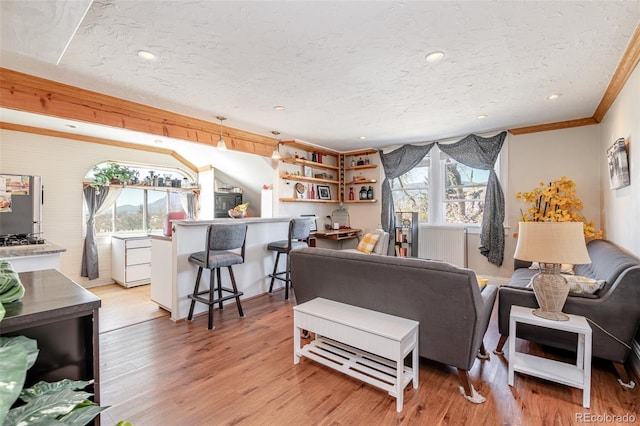 835 N Union Blvd, Colorado Springs, CO 80909 - living area with healthy amount of natural light, light wood-type flooring, crown molding, a textured ceiling, and recessed lighting