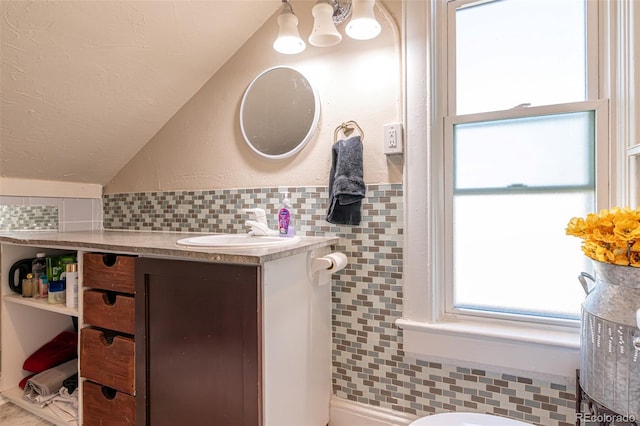 835 N Union Blvd, Colorado Springs, CO 80909 - bathroom with vanity, lofted ceiling, and tasteful backsplash