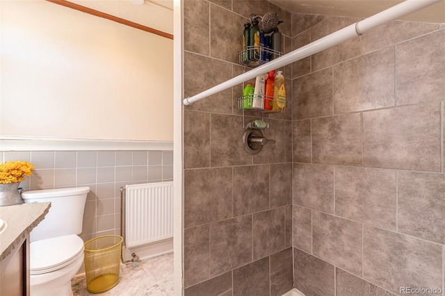 835 N Union Blvd, Colorado Springs, CO 80909 - full bath with radiator, vanity, tiled shower, a wainscoted wall, and marble finish floors