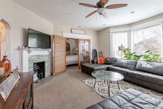 835 N Union Blvd, Colorado Springs, CO 80909 - living area featuring a ceiling fan, a tile fireplace, and a textured ceiling