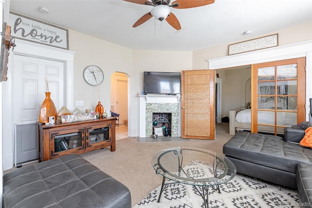 835 N Union Blvd, Colorado Springs, CO 80909 - carpeted living room with a ceiling fan, arched walkways, and a fireplace