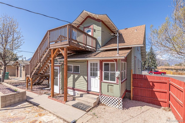 835 N Union Blvd, Colorado Springs, CO 80909 - back of property with entry steps, a shingled roof, a fenced backyard, and a deck