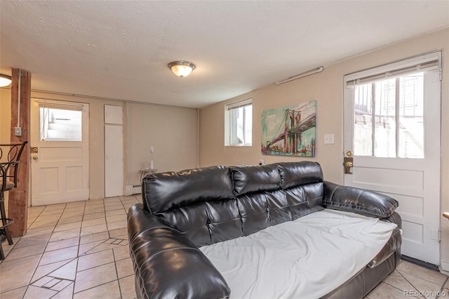 835 N Union Blvd, Colorado Springs, CO 80909 - living area with light tile patterned flooring and a textured ceiling