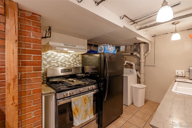 835 N Union Blvd, Colorado Springs, CO 80909 - kitchen with gas range, under cabinet range hood, washer / dryer, freestanding refrigerator, and backsplash