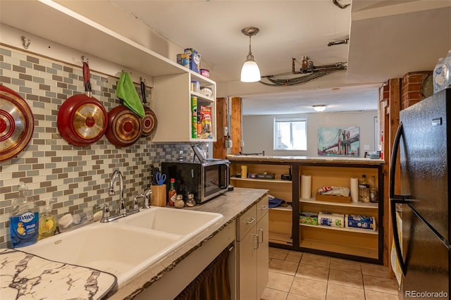 835 N Union Blvd, Colorado Springs, CO 80909 - kitchen with freestanding refrigerator, stainless steel microwave, open shelves, light tile patterned flooring, and decorative backsplash