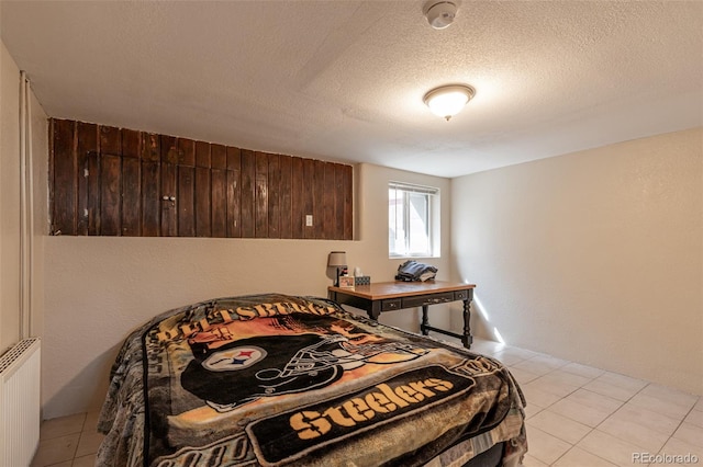 835 N Union Blvd, Colorado Springs, CO 80909 - bedroom with radiator, light tile patterned floors, and a textured ceiling