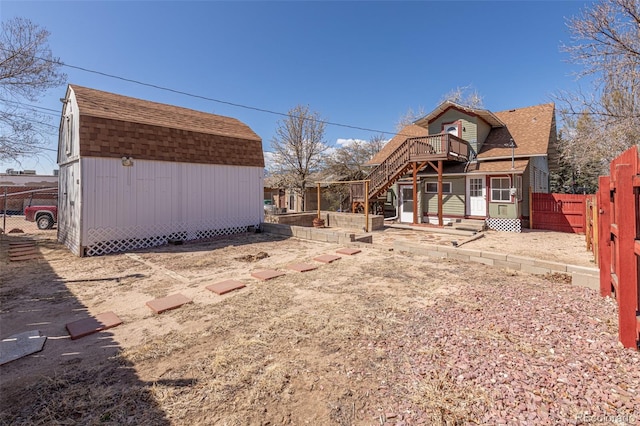 835 N Union Blvd, Colorado Springs, CO 80909 - back of house featuring a shingled roof, a storage shed, stairs, a fenced backyard, and a gambrel roof