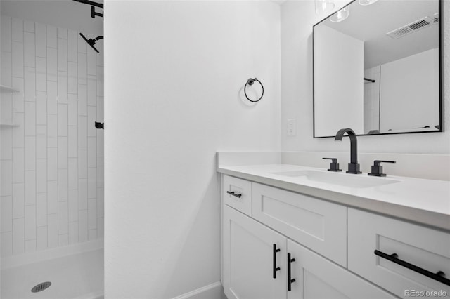 bathroom featuring vanity and a tile shower