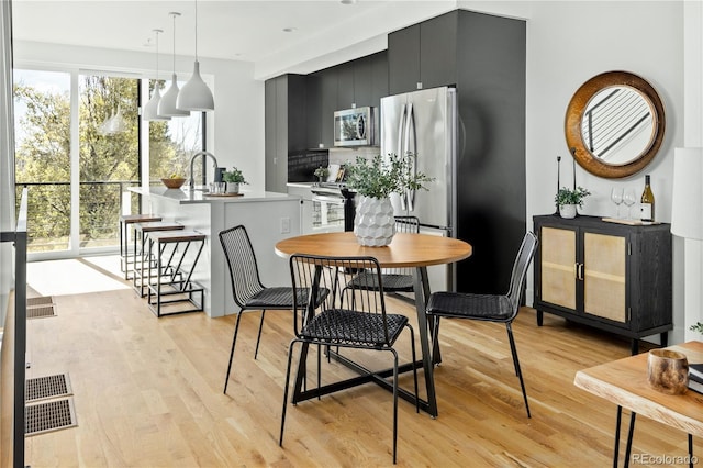 dining area featuring light wood-type flooring