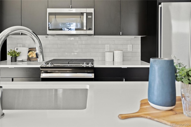 kitchen with tasteful backsplash and appliances with stainless steel finishes