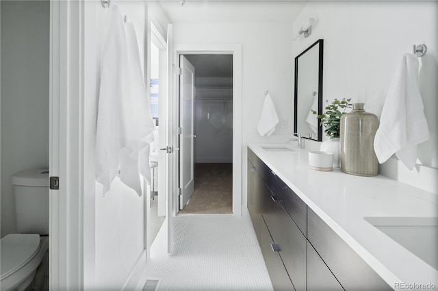 bathroom with tile patterned floors, vanity, and toilet