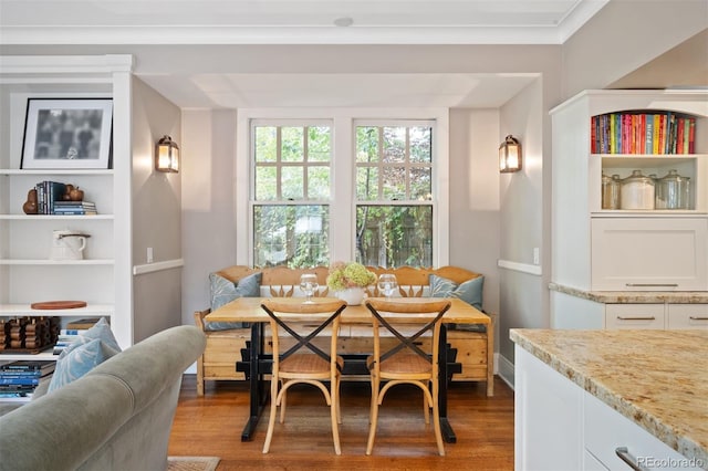 dining room with breakfast area, crown molding, and hardwood / wood-style floors