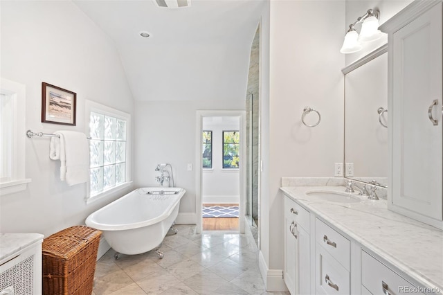 bathroom featuring vanity, lofted ceiling, and shower with separate bathtub