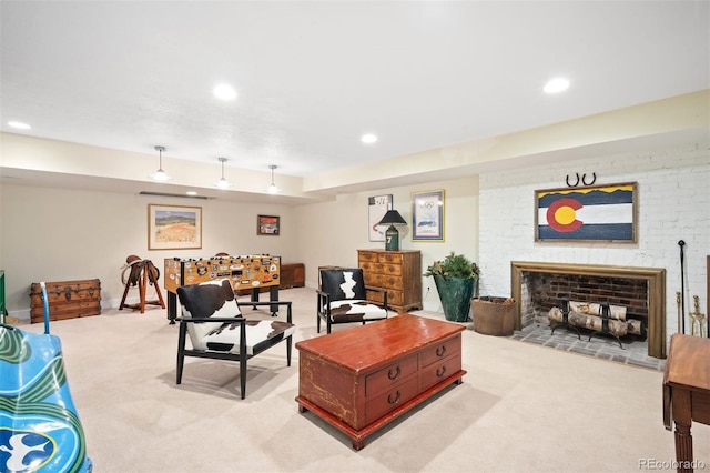 carpeted living room with a large fireplace