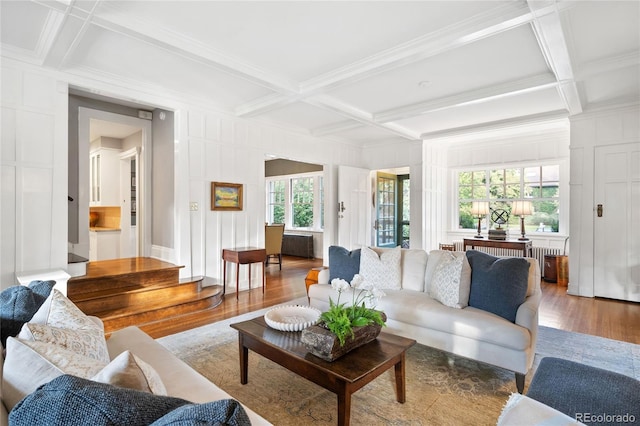 living room featuring coffered ceiling, hardwood / wood-style floors, and a healthy amount of sunlight