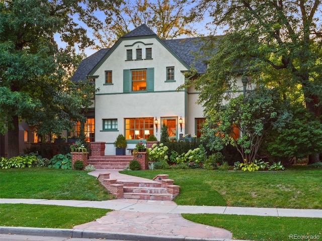 141 N Gilpin St, Denver, CO 80218 - view of front of home featuring stucco siding, roof with shingles, and a front yard