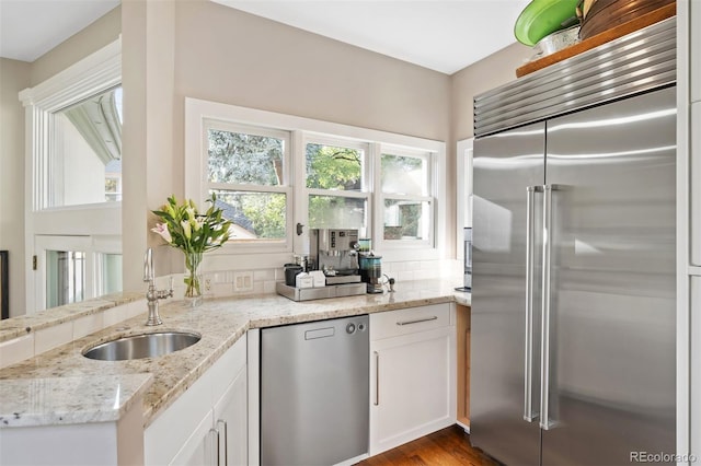 141 N Gilpin St, Denver, CO 80218 - kitchen with appliances with stainless steel finishes, light stone countertops, and white cabinetry