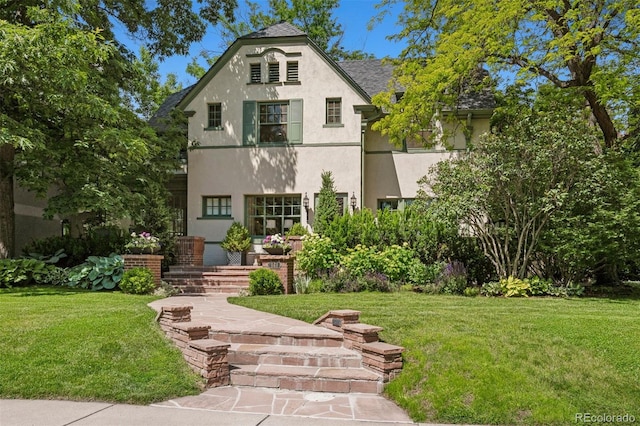 141 N Gilpin St, Denver, CO 80218 - view of front of house featuring stucco siding, a front yard, and a shingled roof