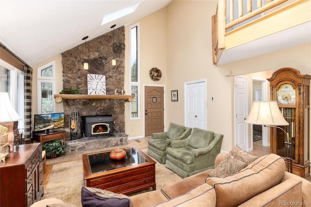 31673 Ponderosa Way, Evergreen, CO 80439 - living room with high vaulted ceiling, healthy amount of natural light, a stone fireplace, and a skylight