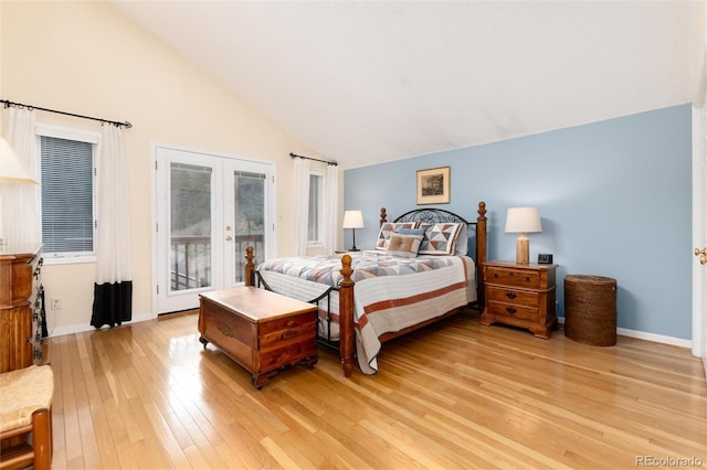 31673 Ponderosa Way, Evergreen, CO 80439 - bedroom with french doors, access to exterior, light wood-style flooring, and high vaulted ceiling