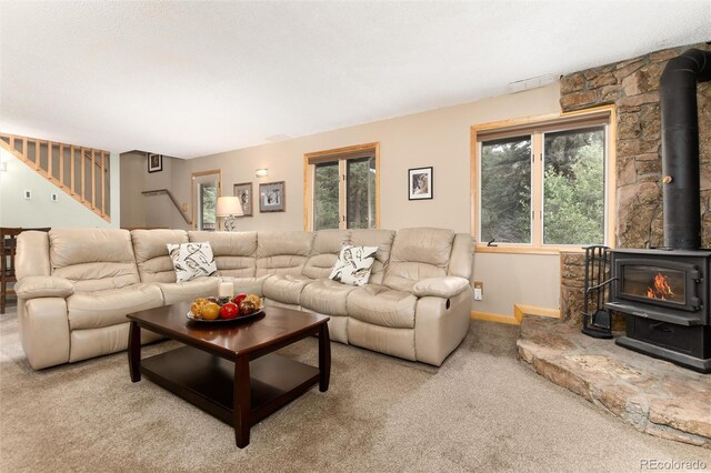31673 Ponderosa Way, Evergreen, CO 80439 - carpeted living room featuring a wood stove and stairs