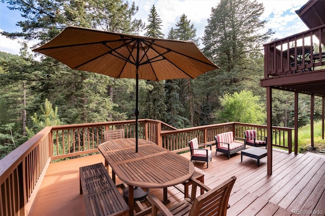 31673 Ponderosa Way, Evergreen, CO 80439 - deck featuring an outdoor living space and outdoor dining area