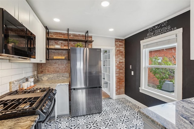4883 Perry St, Denver, CO 80212 - kitchen featuring freestanding refrigerator, black microwave, gas range oven, tasteful backsplash, and crown molding