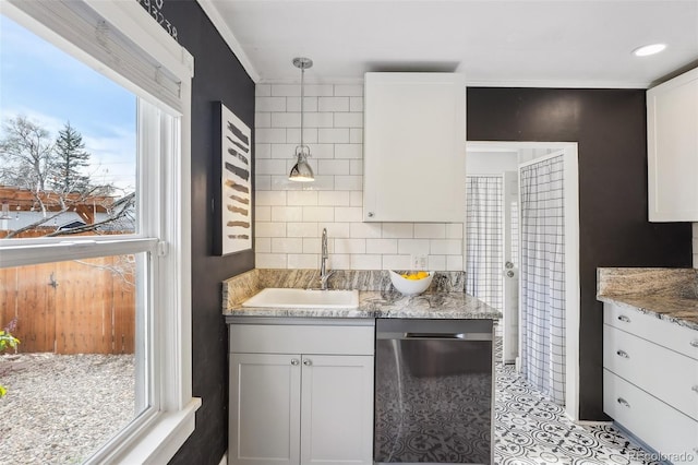 4883 Perry St, Denver, CO 80212 - kitchen with dishwasher, healthy amount of natural light, white cabinetry, and light stone counters