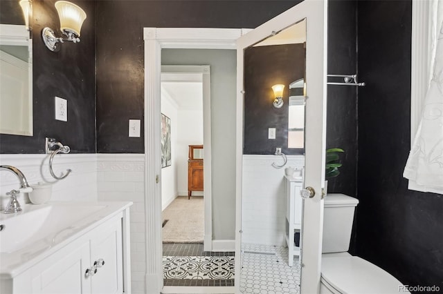 4883 Perry St, Denver, CO 80212 - bathroom featuring vanity, tile patterned flooring, and a wainscoted wall