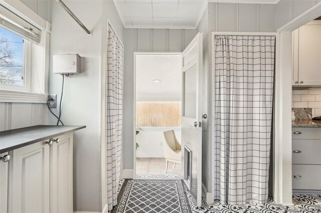 4883 Perry St, Denver, CO 80212 - bathroom with tasteful backsplash and tile patterned floors