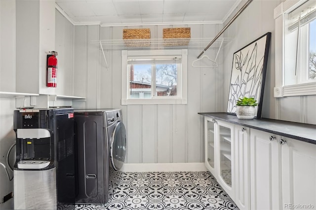 4883 Perry St, Denver, CO 80212 - laundry area featuring crown molding, washer / dryer, and light tile patterned flooring