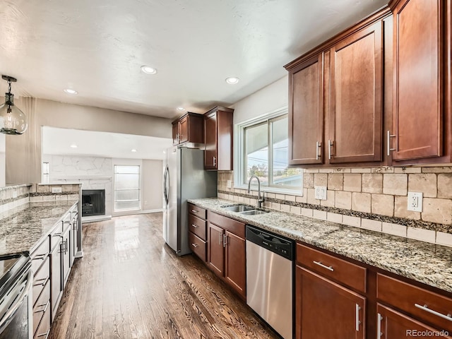 170 W Midway Blvd, Broomfield, CO 80020 - kitchen featuring stainless steel appliances, a sink, dark wood-type flooring, light stone counters, and recessed lighting