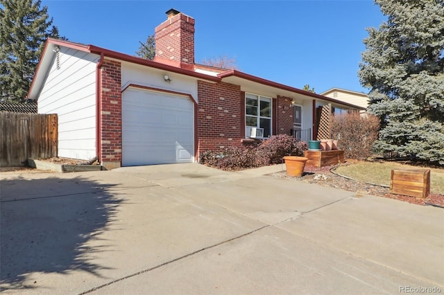 ranch-style house with an attached garage, brick siding, fence, concrete driveway, and a chimney