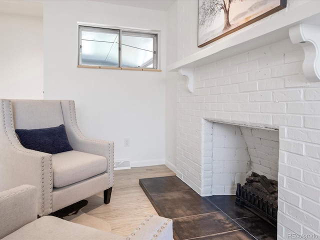 sitting room with wood-type flooring