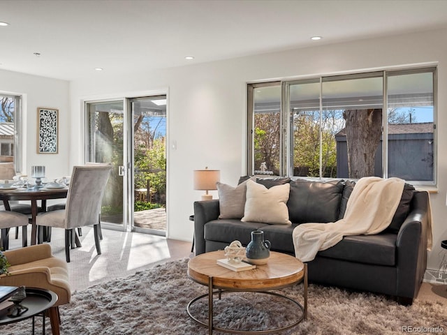 living room with a healthy amount of sunlight and light colored carpet