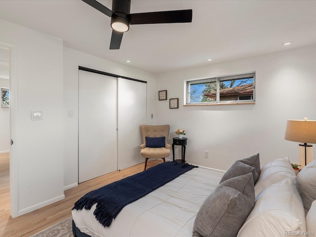 bedroom with ceiling fan, a closet, and light wood-type flooring