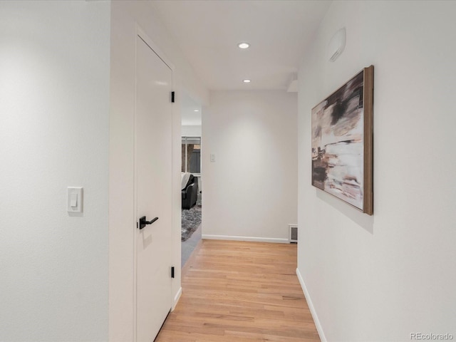 hall with light hardwood / wood-style floors