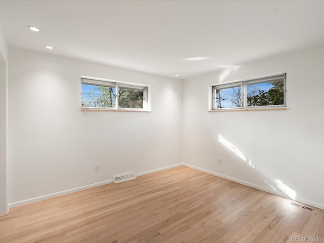 spare room featuring light hardwood / wood-style floors