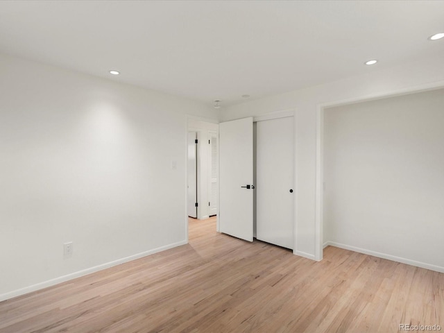 unfurnished room with light hardwood / wood-style floors