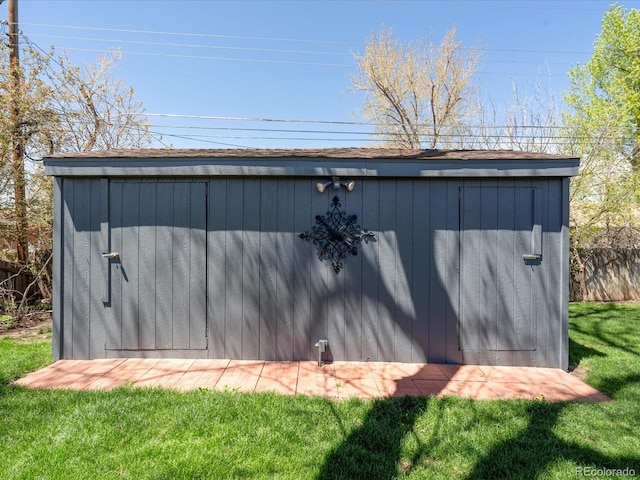 view of outbuilding with a yard