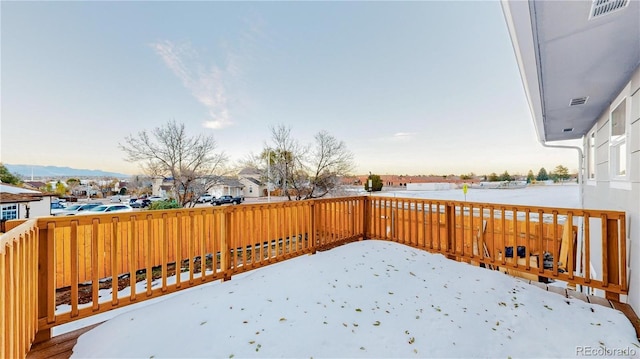 snowy yard featuring visible vents and a mountain view