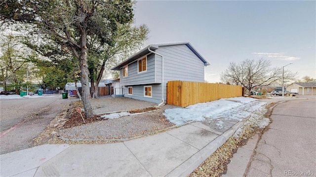 view of side of property featuring fence