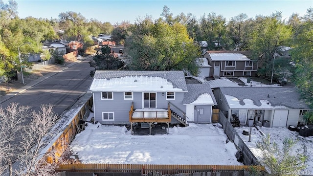 rear view of house featuring a wooden deck, a residential view, and fence