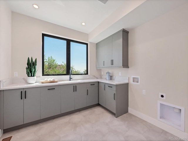 laundry room with cabinets, hookup for a washing machine, sink, and electric dryer hookup