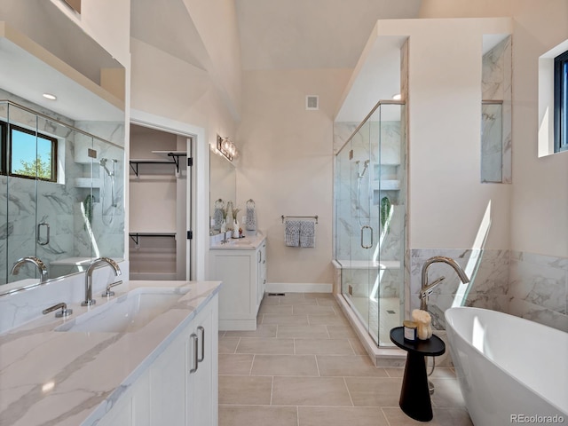 bathroom featuring vanity, tile patterned flooring, and plus walk in shower